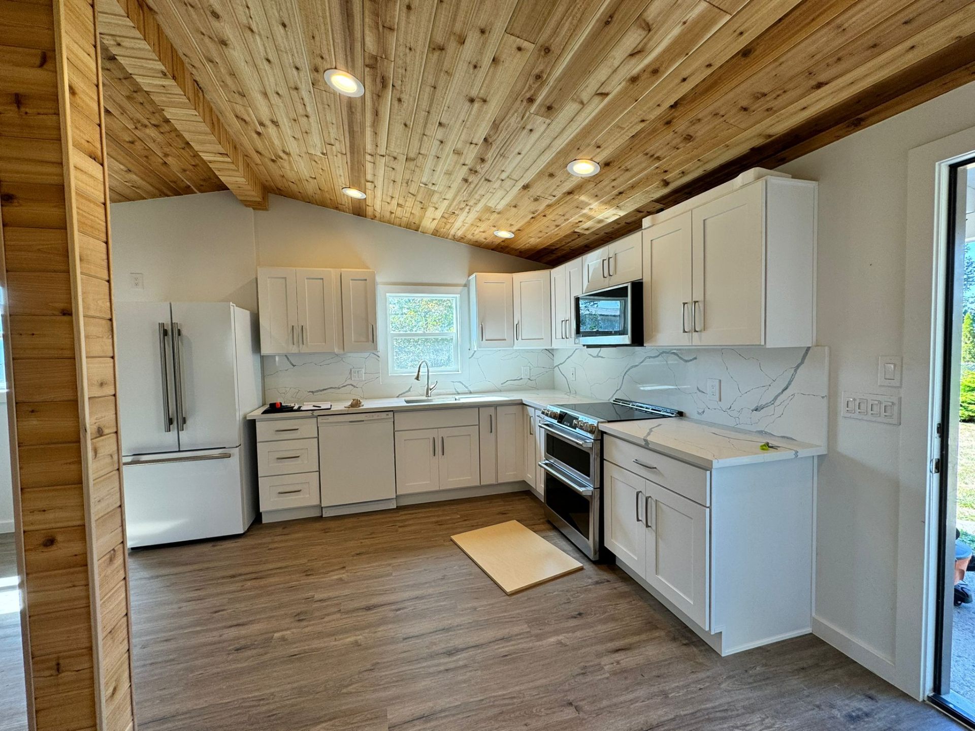 ADU kitchen remodel with wood ceiling and white cabinets in Portland