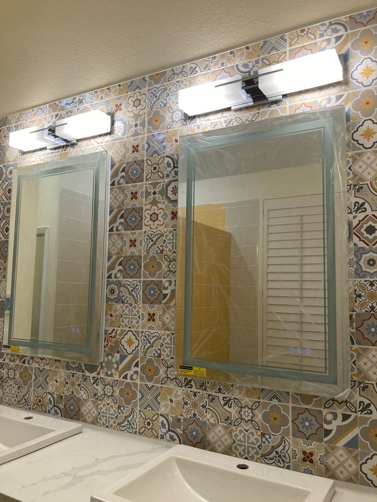 Bathroom with Moroccan patterned tile, double sink vanity and twin mirrors in Portland