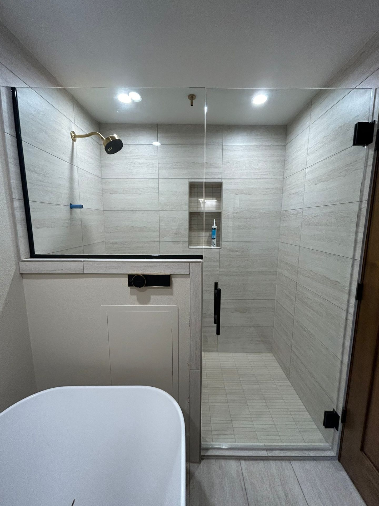 Bathroom remodel with frameless glass shower and freestanding tub in Portland