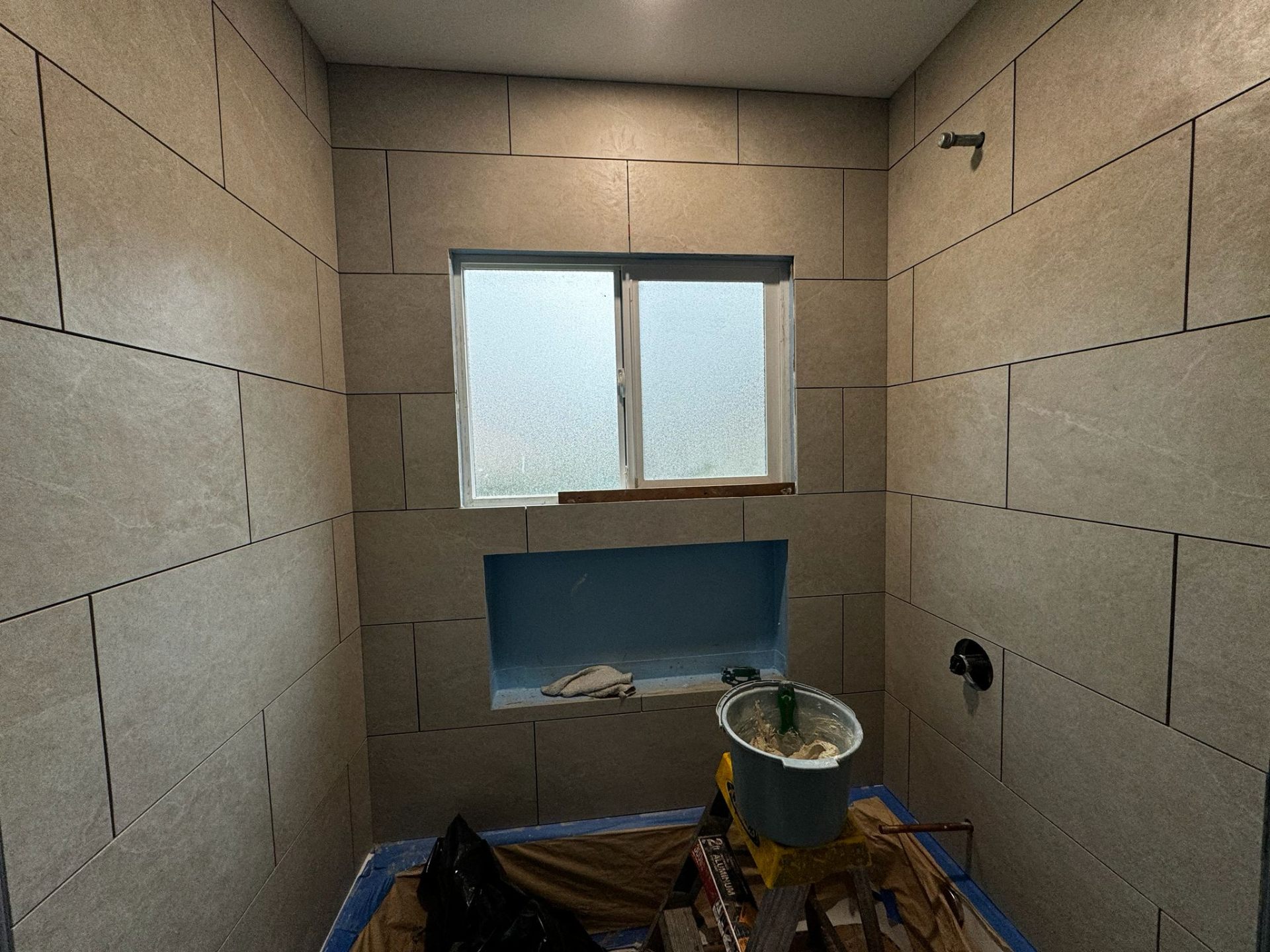 Bathroom shower with large-format gray tile installation in Portland