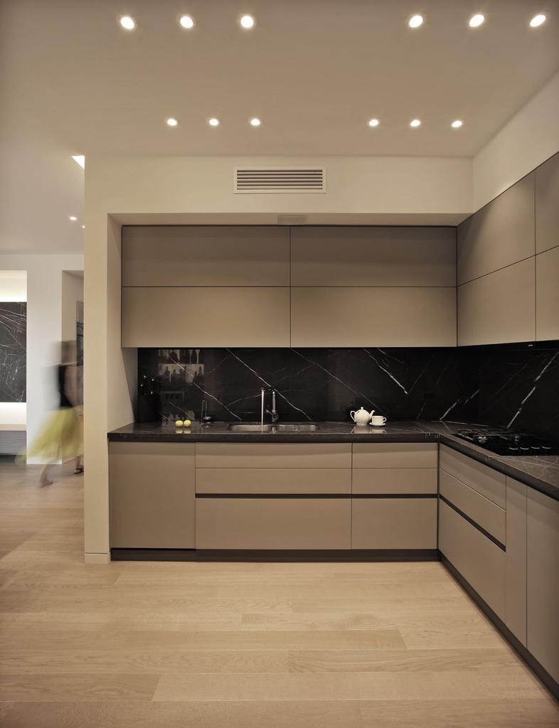 Contemporary taupe kitchen with black marble backsplash in Portland