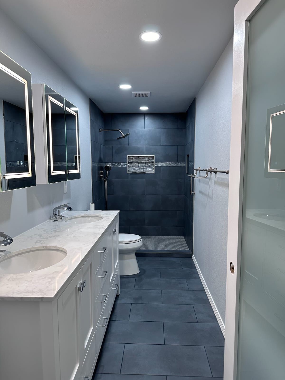 Dark tile bathroom remodel with marble vanity in Portland