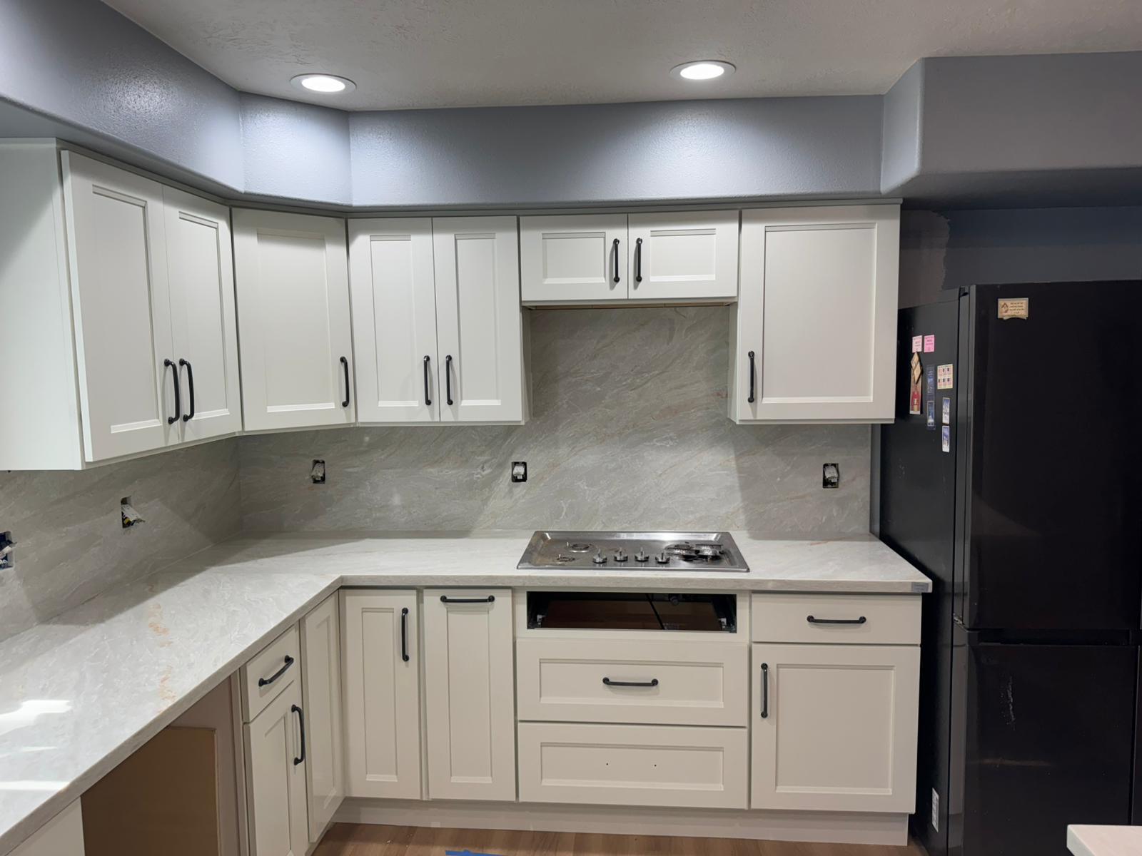 Kitchen backsplash tile installation with white cabinets in Portland