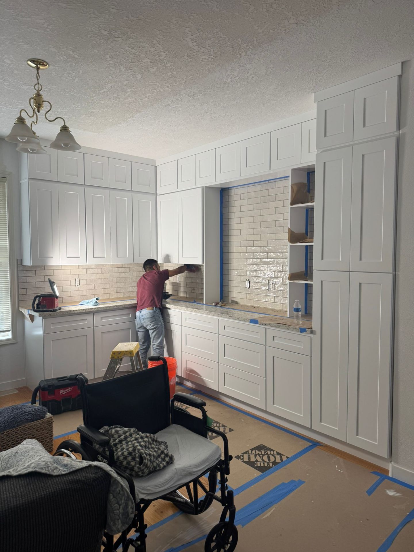 Subway tile backsplash installation in progress on kitchen remodel in Portland