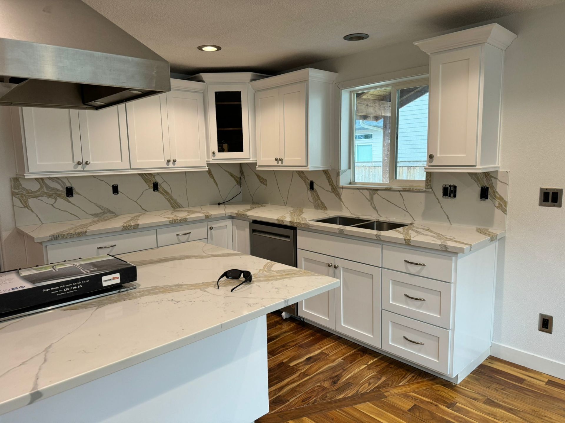Kitchen renovation with white shaker cabinets and marble backsplash in Portland
