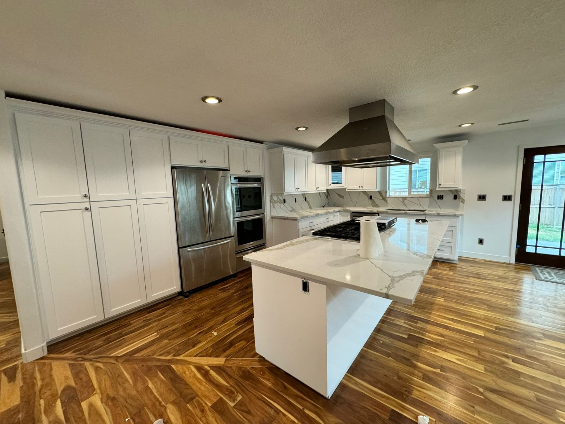 Large kitchen remodel with white cabinets and quartz island in Portland