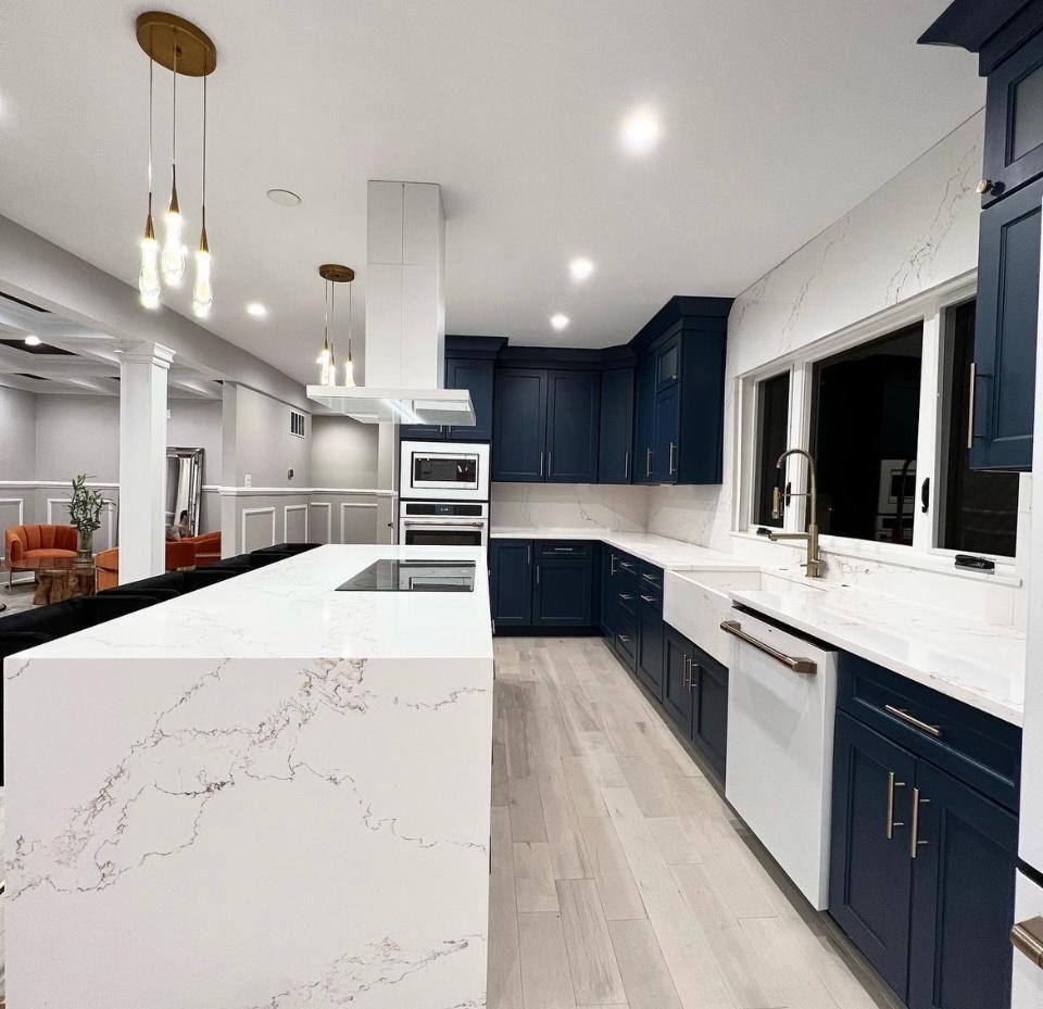 Navy blue kitchen with pendant lights and farmhouse sink in Portland