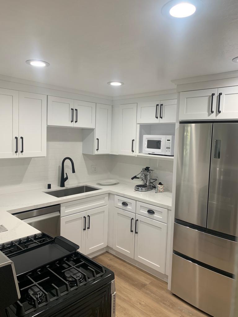 White kitchen remodel with black hardware and stainless appliances in Portland